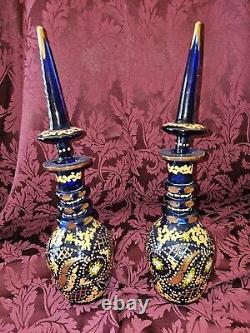 A PAIR OF BOHEMIAN CUT AND ENAMELLED BLUE GLASS DECANTERS AND STOPPERS. 19th Cen
