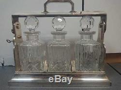 A silver plated three bottle tantalus, DECANTER