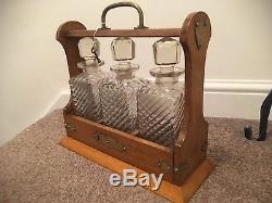 Antique Oak & Brass Tantalus With Three blown and hand cut glass decanter