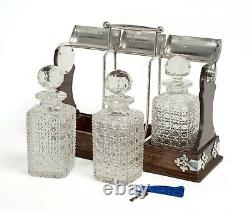 Antique Tantalus with 3 Cut Glass Decanters In Oak & Silver Plate Locking Frame