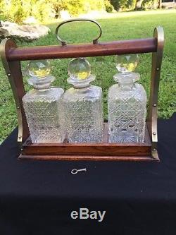 Antique Victorian Tantalus cut glass decanters In Locking Oak Case