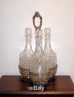 Antique silver plated decanter holder, Mappin Bros and three cut glass decanters