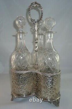 English Silver Tantalus Set with 3 Cut Crystal Decanters