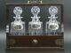 Mahogany Three Bottle Tantalus With Silver Decanter Lables Whisky, Gin, Brandy