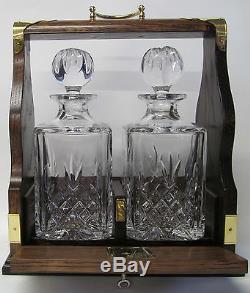 Two Decanter Tantalus In Solid Oak Frame With Brass Fittings
