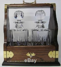 Two Decanter Tantalus In Solid Oak Frame With Brass Fittings (Crystalite)