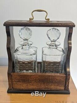 Vintage lockable oak tantalus with key and two Edinburgh Crystal decanters whi